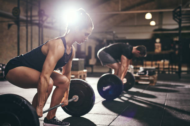 istock Sportive people holding barbells before doing deadlift 838389528