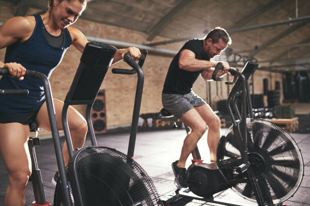 istock Two males riding fast on cycling machines 838389606
