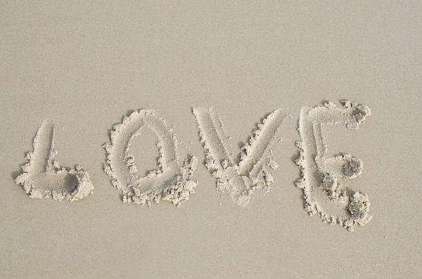istock Love  written in soft wet sand on a beach 838390380