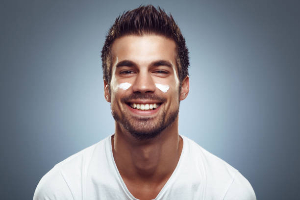 istock Young man with moisturizer on the face 838392780