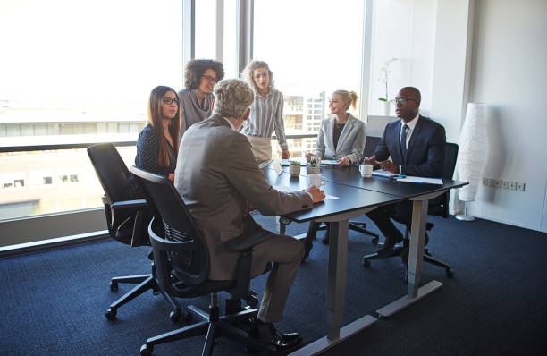 istock Work colleagues discussing business together in an office boardroom 838395616