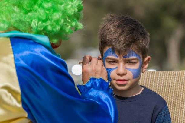 istock Little boy having face painted on birthday party 838395646