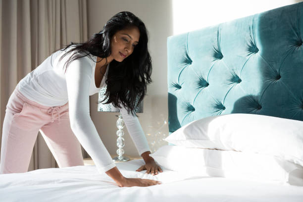 istock Young woman making bed 838398776
