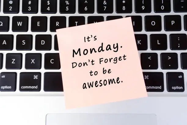 Monday inspirational greeting - Its Monday, don't forget to be awesome written on stick on paper on top of laptop keyboard