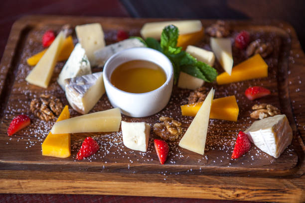 istock various cheeses with nuts and berries on a wooden Board 838402394