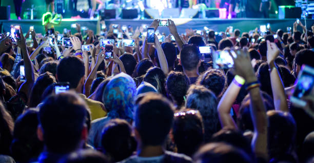istock People filming a concert 838405592