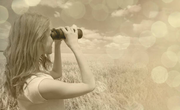 istock girl with binocular at wheat field. 838409166