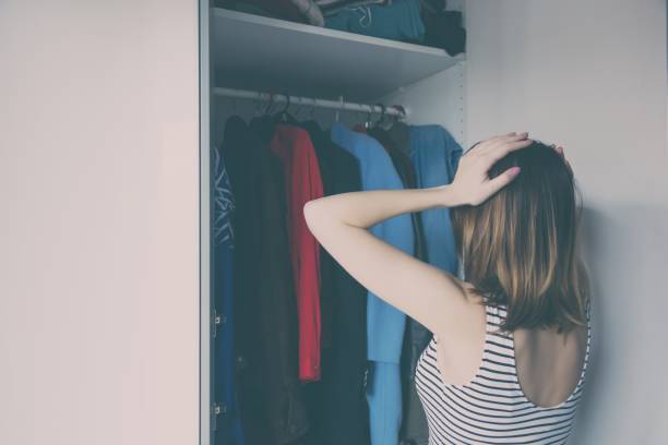 istock Young rednead girl choosing a clothes 838409910