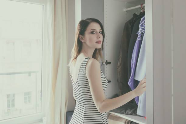 istock Young rednead girl choosing a clothes 838409936