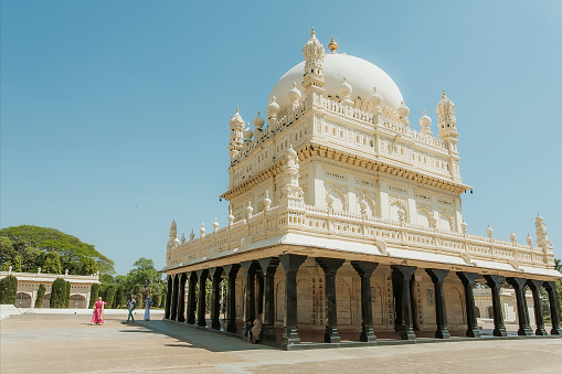 Srirangapatna, India - February 18, 2017: Great example of Mughal architecture, building of Tipu Sultan Gumbazigh with white roof on February 18, 2017. Park with the 18th century Muslim mausoleum.