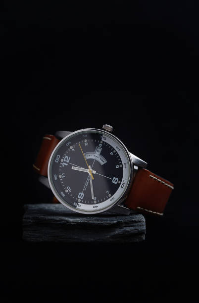 istock Wrist watch with a black dial on a gray stone with a dark background. 838414094