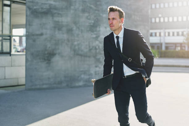 istock Confident handsome worker holding skateboard and walking 838416230