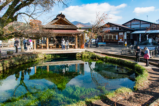 People visiting the Mt Fuji visitor center during a cold autumn day in Japan. In the visitor center people can buy souvenirs and eat at restaurants.