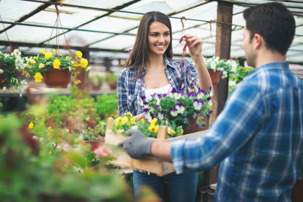 istock Young couple working in a greenhouse with flowers 838418290