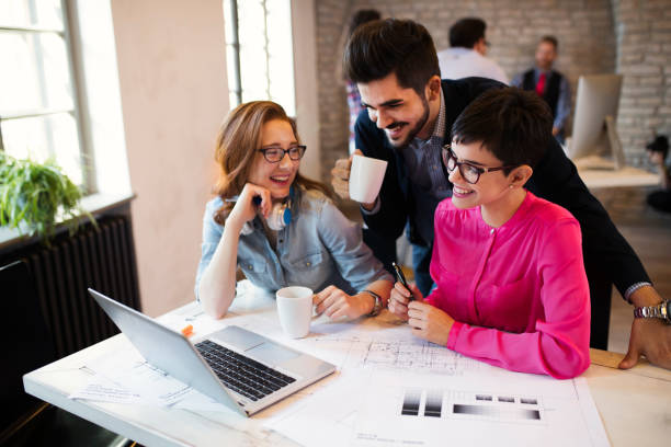 istock Group of young architects working on laptop 838420650