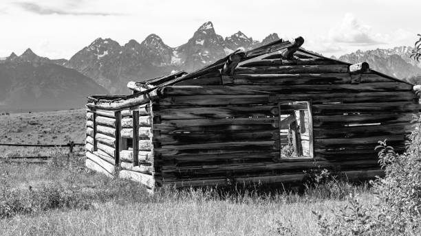 istock Old log cabin with Grand Teton Mountain range in the background 838425188