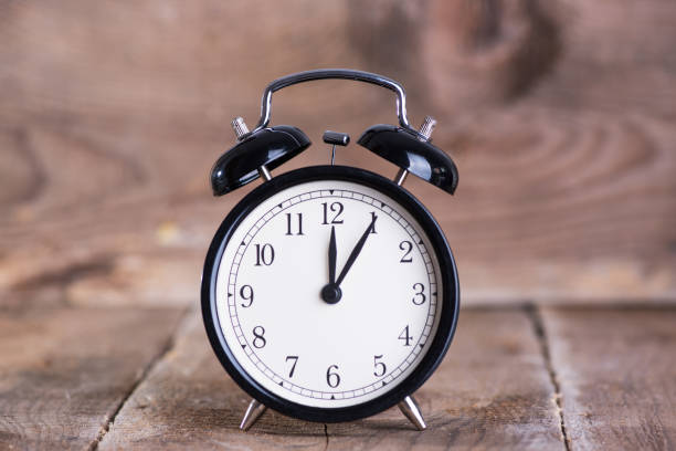 istock Alarm clock on wooden background 838430098