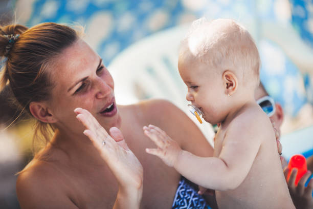 Young mother and her baby having fun time Young mother and her baby having fun time outside outing tantarum in babies stock pictures, royalty-free photos & images