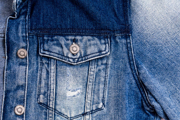 Blue jeans jacket background closeup detail of blue vintage denim jacket. Fashion, textures and backgrounds denim jacket stock pictures, royalty-free photos & images
