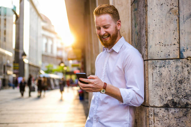 istock Businessman using smart phone at city square 838443462