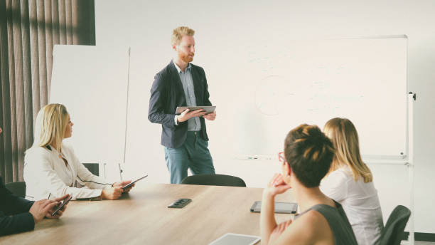 istock Man holding presentation to his colleague 838454764
