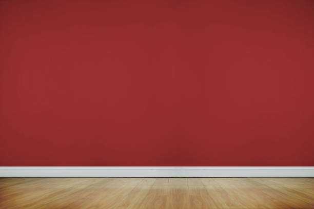 Room with wooden floor with red wall