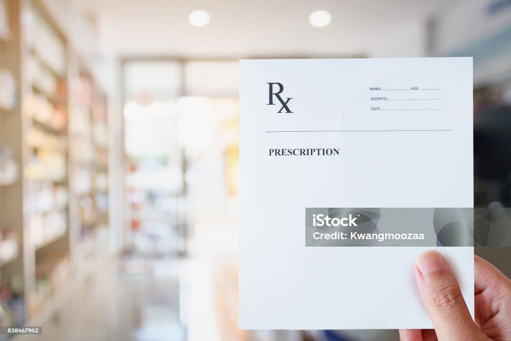 Pharmacist hold blank prescription in pharmacy store Prescription Stock Photo