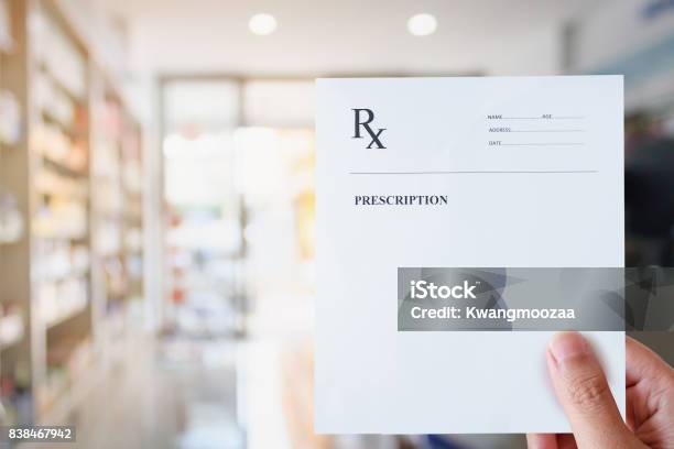 Pharmacist Hold Blank Prescription In Pharmacy Store Stock Photo - Download Image Now