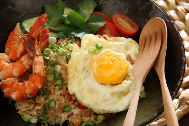 Photo of Gourmet Fried Rice, Indonesian Fried Rice Served Luxuriously with Prawns, Sunny Side Egg on Fancy Dishware