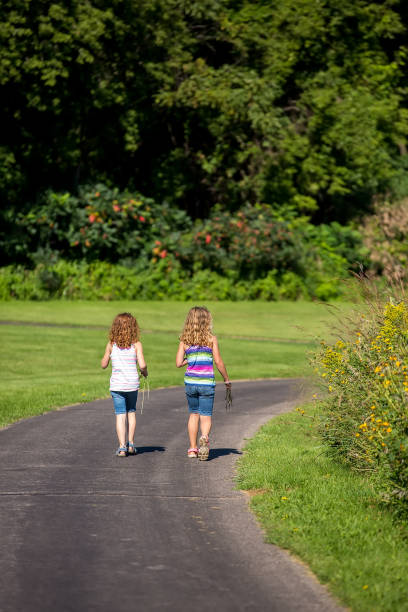 istock Girls Walking On Paved Path in Late Summer 838472384
