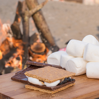 Smores Ingredients at a Beach Bonfire with Chocolate, Marshmellow, and Graham Crackers with Room for Copy
