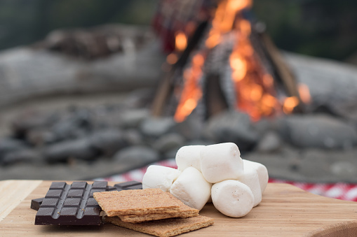 Smores Ingredients at a Beach Bonfire with Chocolate, Marshmellow, and Graham Crackers with Room for Copy