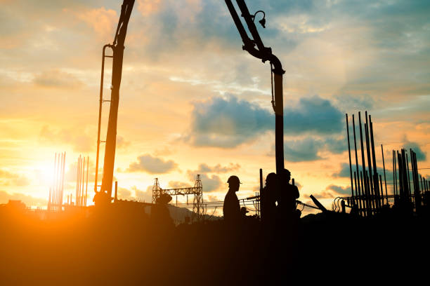 istock Silhouette construction industry team safely to work load concrete building according to set goal over blurred background sunset pastel for industry background.with Light fair 838475358