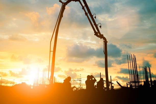 istock Silhouette construction industry team safely to work load concrete building according to set goal over blurred background sunset pastel for industry background.with Light fair 838475432
