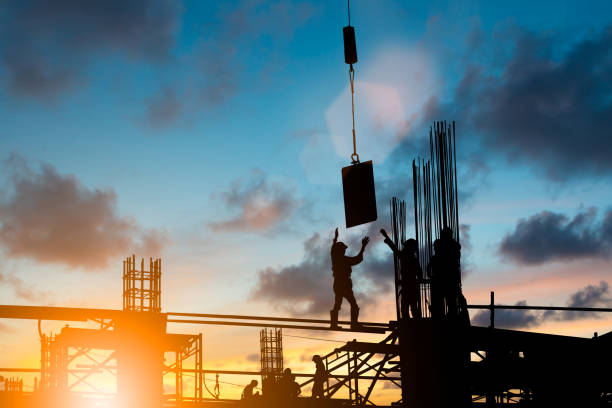 istock Silhouette construction industry team safely to work load concrete building according to set goal over blurred background sunset pastel for industry background. 838475528