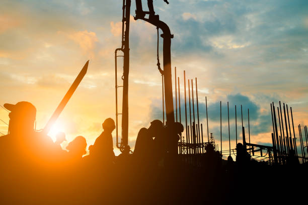 istock Silhouette construction industry team safely to work load concrete building according to set goal over blurred background sunset pastel for industry background.with Light fair 838476322