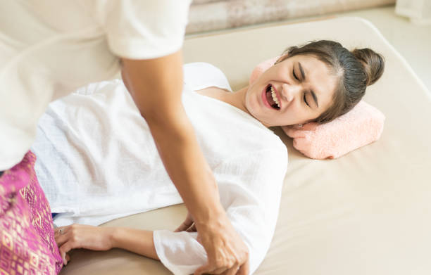 istock Women is hurting while Therapist is pushing her arm for reflexology in Thai massage course 838476552