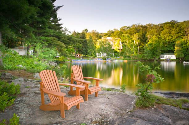 istock Muskoka chairs on a rock formation facing a calm lake 838477236