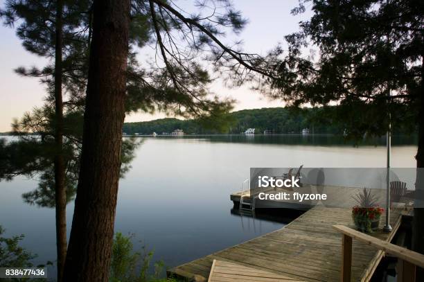 Muskoka Chairs On A Wooden Dock Stock Photo - Download Image Now - Cottage, Lake, Muskoka