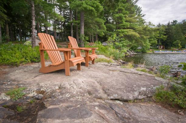 istock Light brown Muskoka chairs on a rock formation 838477556