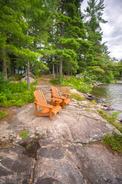 istock Light brown Muskoka chairs on a rock formation 838477814