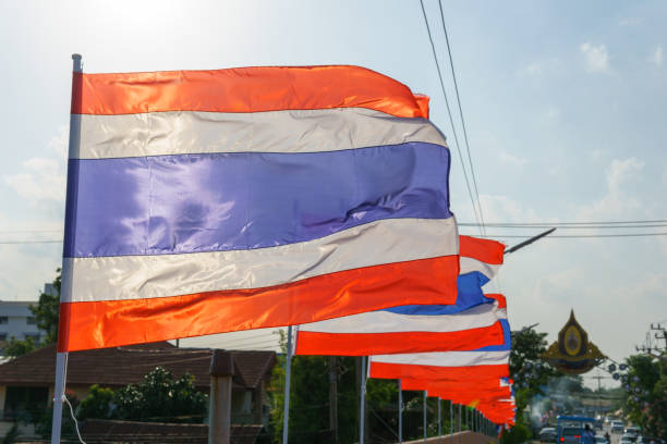 istock close up thai flags on the pole blown by wind in sunny and cloudy day. 838479162