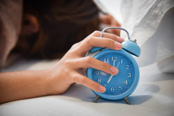 istock Sleepy Asian woman holding Alarm clock. 838479326