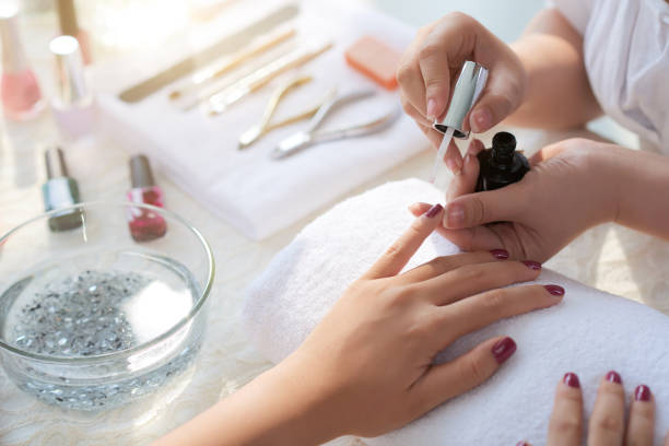 Manicure process Close-up image of woman having her nails done in beauty salon beautician stock pictures, royalty-free photos & images