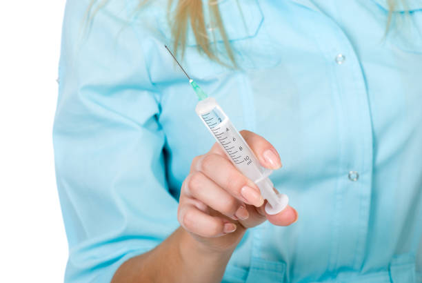 Image of surgeon holding syringe in hand on white background.Horizontal image