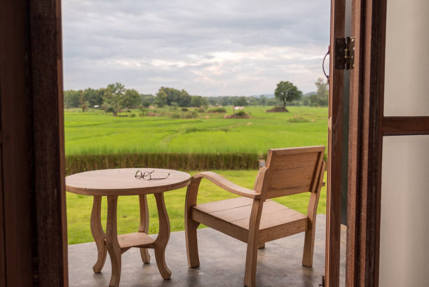 istock Glass on table with rice field background. 838484190