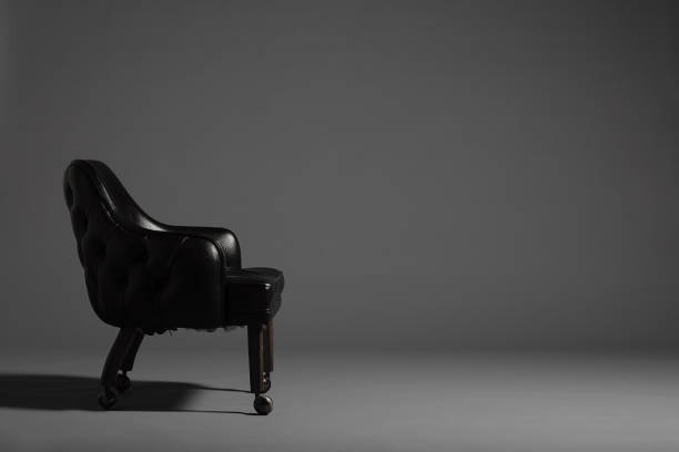 istock Single Black Vintage Leather Chair in front of a grey background 838484212