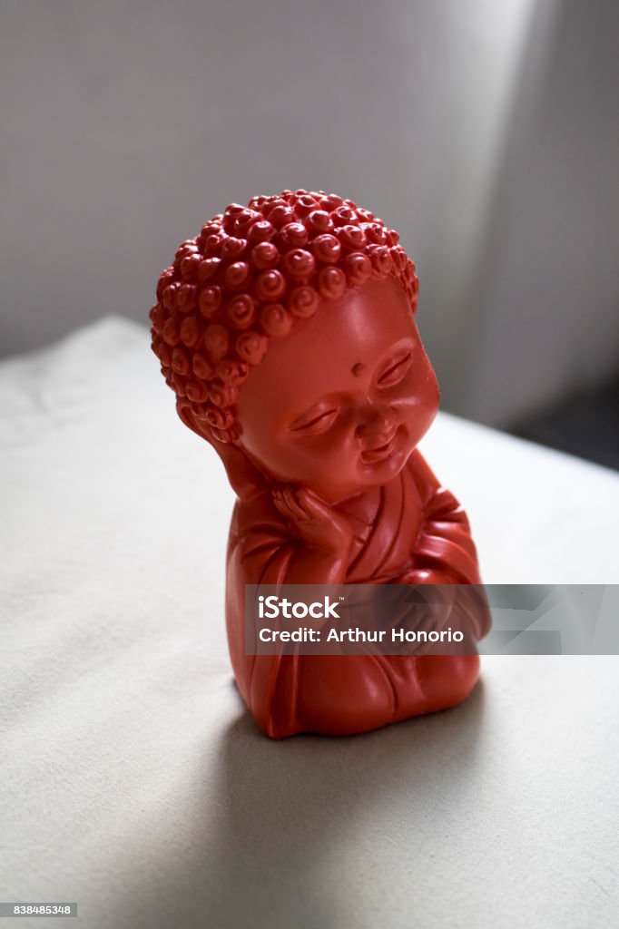 Beautiful and cute red buddha of love replica. Loving childish Buddha replica. Activity Stock Photo