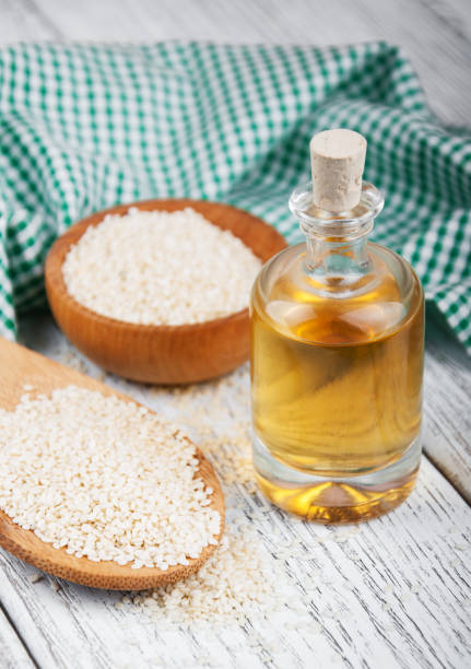 istock Sesame seeds and bottle with oil 838488314