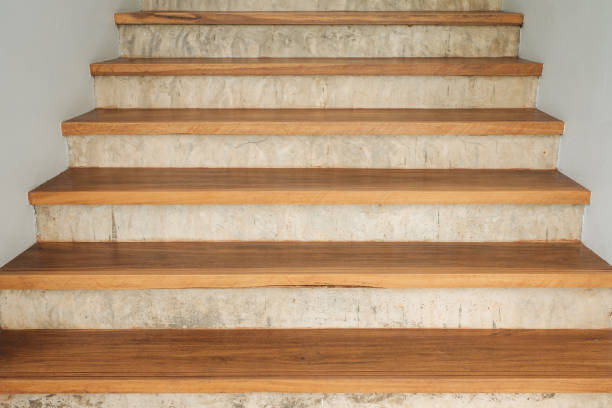 istock Wood staircase on concrete and white wall. 838488788